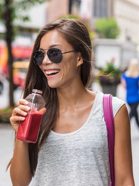 A woman enjoying a smoothie