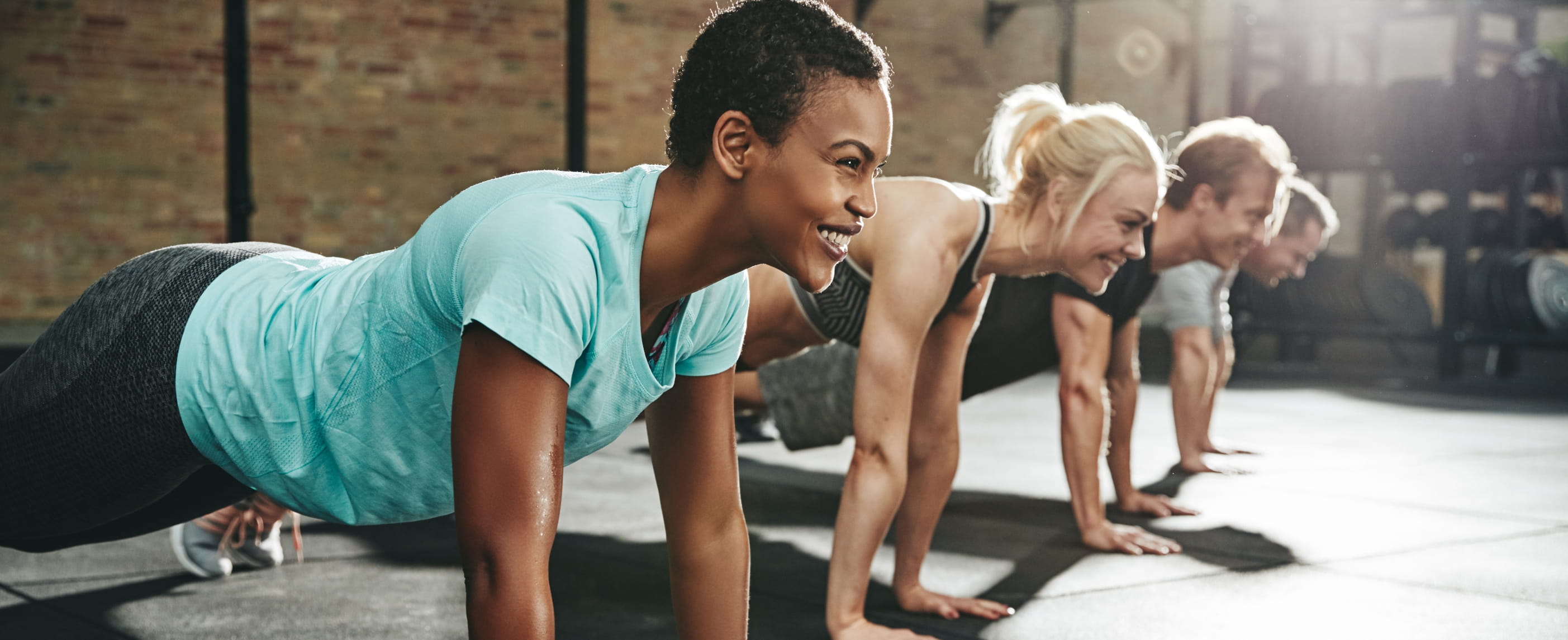 A group of men and women attend an exercise class