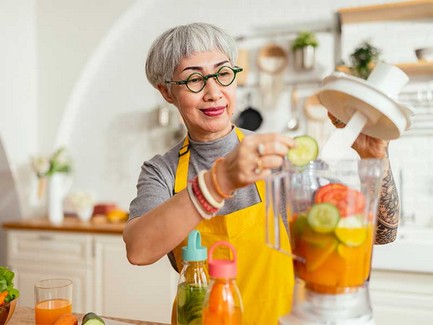 senior-woman-preparing-fruit-juice