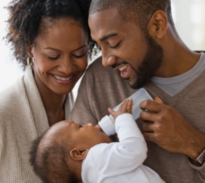 Couple giving bottle to their baby