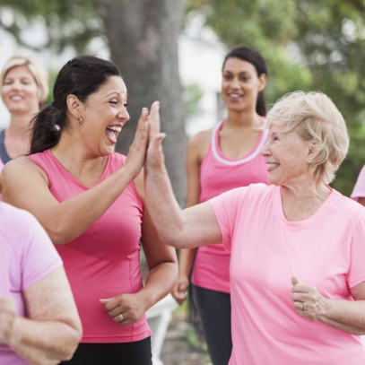 women clapping while running