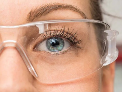 Eye of a scientist wearing protective glasses