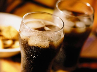 A dark beverage with ice cubes.