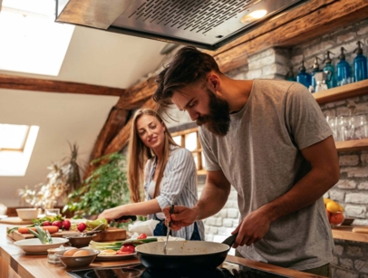 A man and a woman cooking in a kitchen