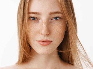 A woman with long red hair smiles