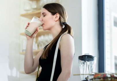 Women who is enjoying a protein ready to drink beverage.
