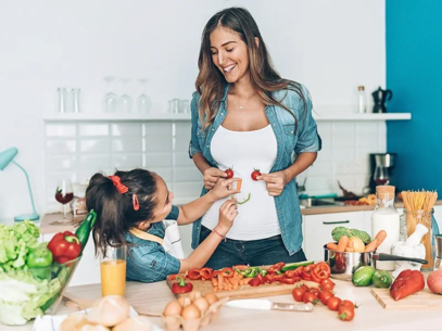 Woman cooking with her daughter