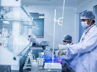 Scientists with surgical masks in a laboratory