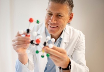 Pharmaceutical scientist examining a molecular model