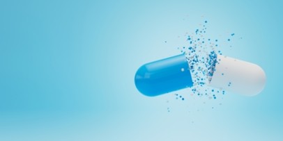 Two-piece capsule releasing fine particles, illustrating disintegration and enhanced drug delivery.