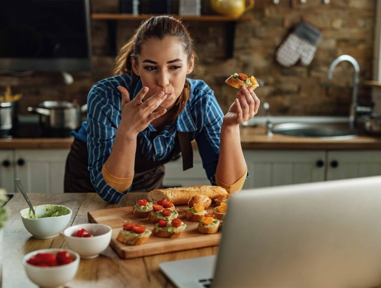 woman enjoying guacamole on toast