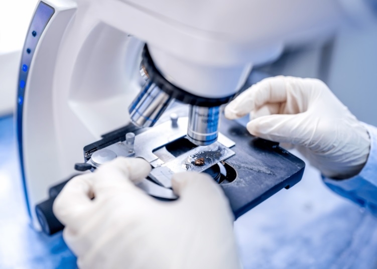 A close up of a scientist working using a microscope