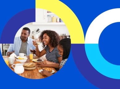 Family sharing breakfast with pastries, fruit, and juice in a kitchen, with an abstract blue and yellow background.